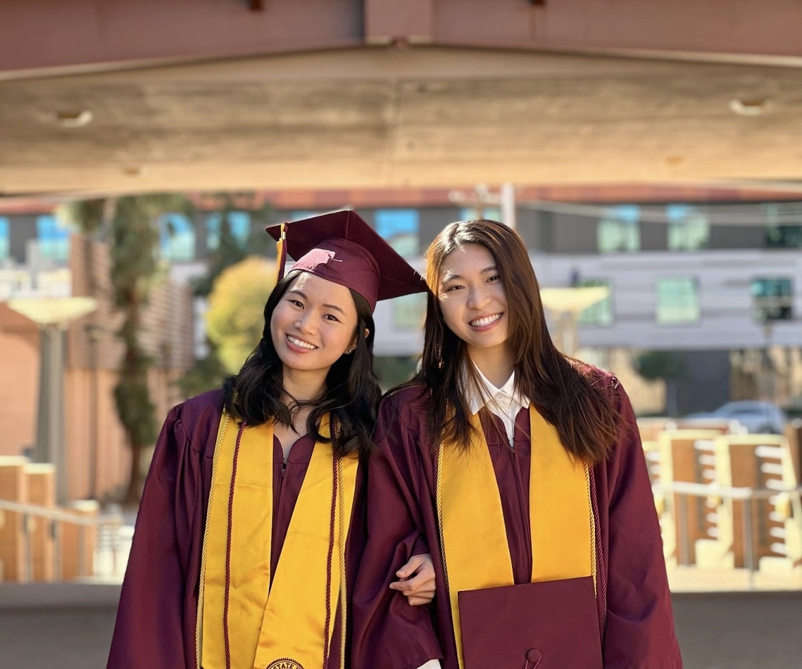Two ASU Students Standing together smiling at graduation