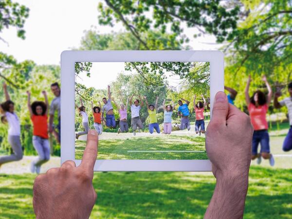 a person holding picture frame on grass