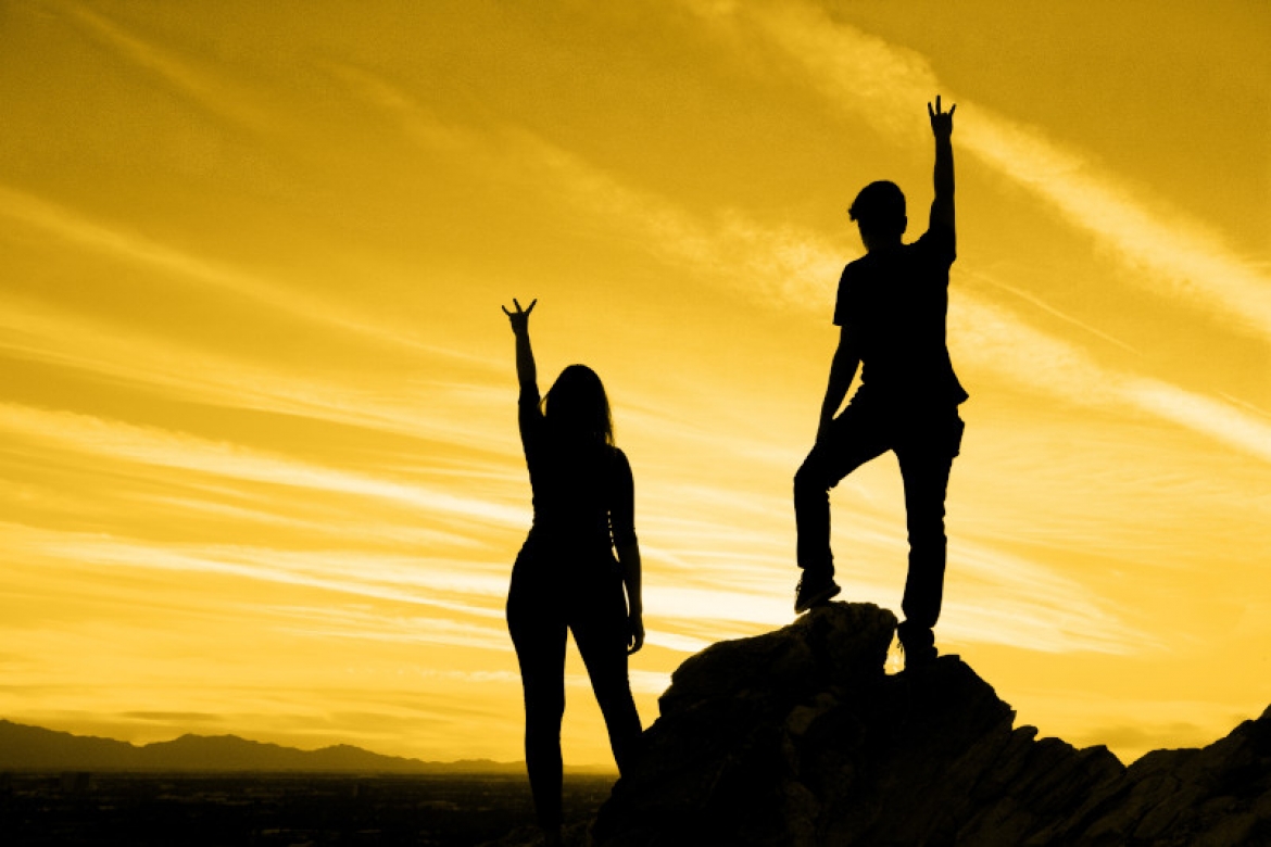 Two ASU students on mountain with yellow background